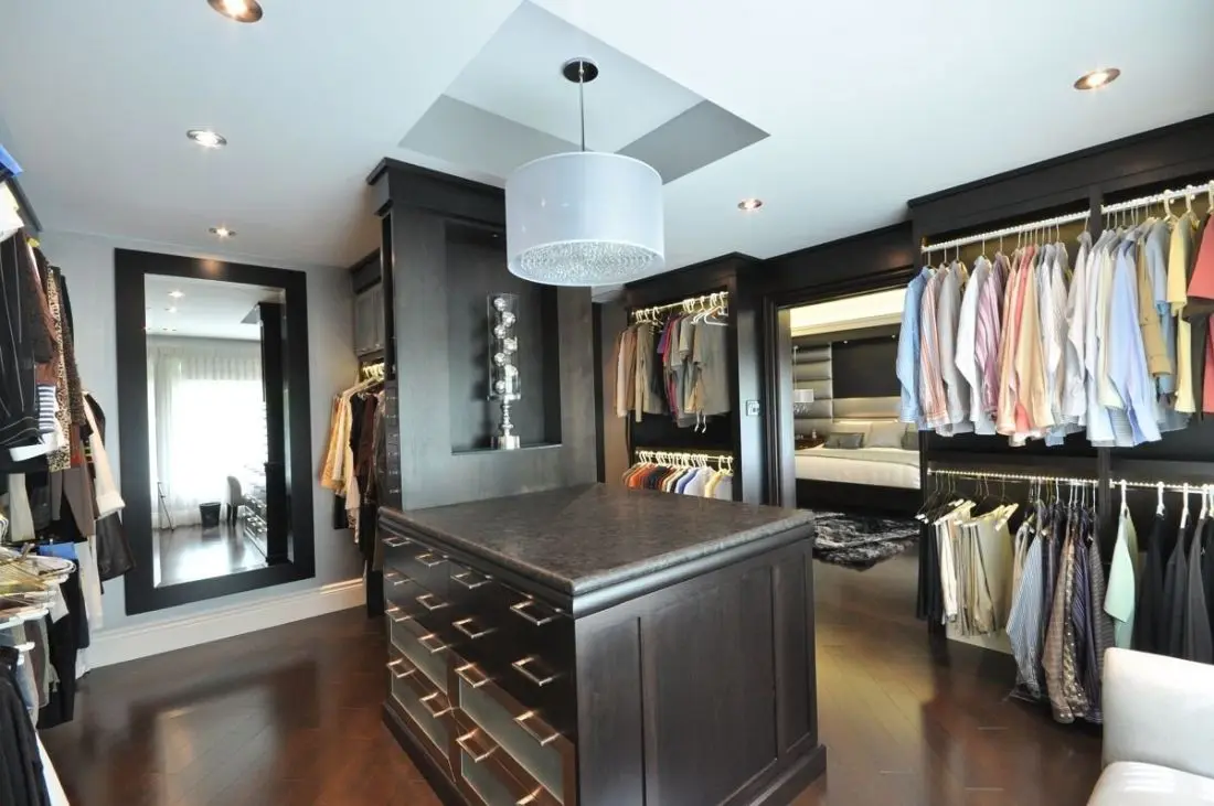 Spacious custom walk-in closet designed by Homestead Woodworks, featuring modern shelving, storage solutions, and an elegant center island